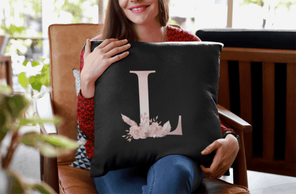 Custom Printed Monogram Letter J on Black Pillow Case mockup of a smiling woman holding a pillow