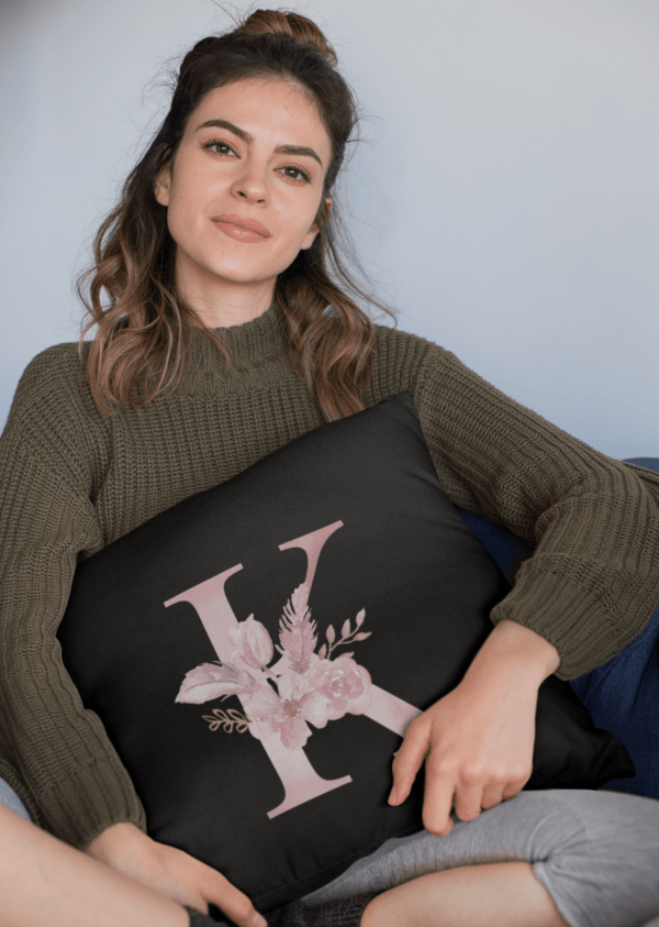 Custom Printed Monogram Letter K on Black Pillow Case mockup of a woman holding a square pillow while sitting