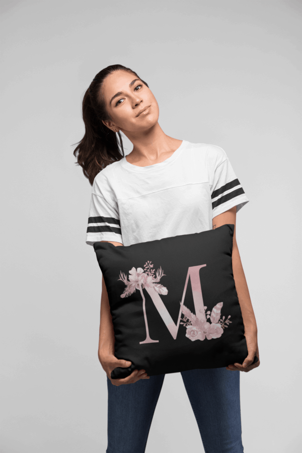 Custom Printed Monogram Letter M on Black Pillow Case mockup of a woman holding a pillow against a flat background