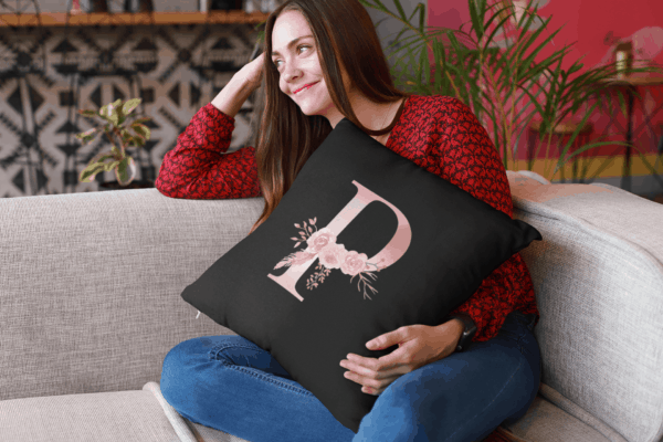 Custom Printed Monogram Letter P on Black Pillow Case mockup of a happy girl holding a pillow sitting on a sofa