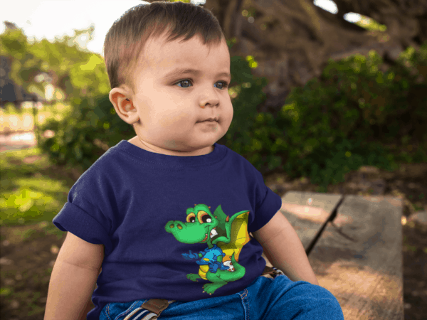Dinosaur Dragon on Toddler T-Shirt little baby boy wearing a round neck tee mockup while sitting down outdoors