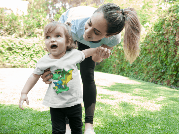 Dinosaur Dragon on Toddler T-Shirt mockup of a smiling baby girl wearing a t-shirt with her mom