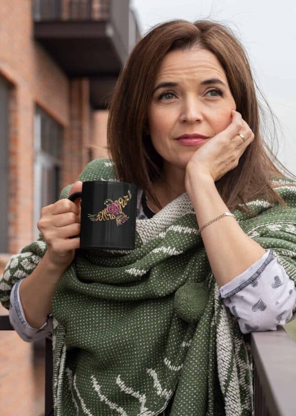 Follow Your Heart Coffee Mug Design Black mockup of a middle aged woman holding an 11oz coffee mug outside