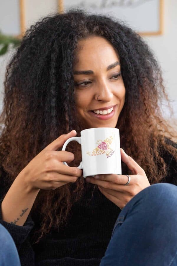 Follow Your Heart Coffee Mug Design White mockup of a curly haired woman with an 11oz mug in her hands