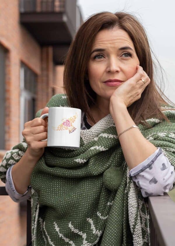 Follow Your Heart Coffee Mug Design White mockup of a middle aged woman holding an 11oz coffee mug outside
