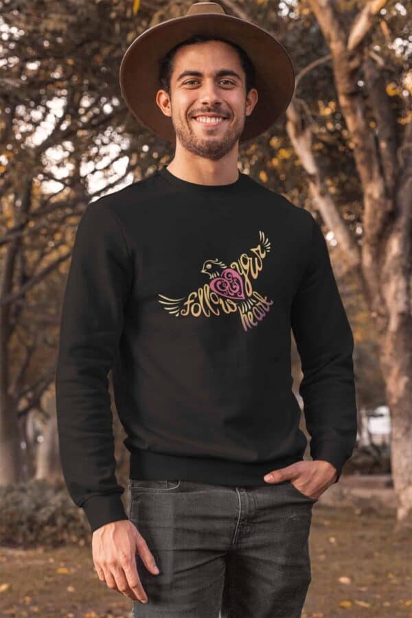 Follow Your Heart Crewneck Sweat Shirt Design Black crewneck sweatshirt mockup of a man posing at a park during autumn