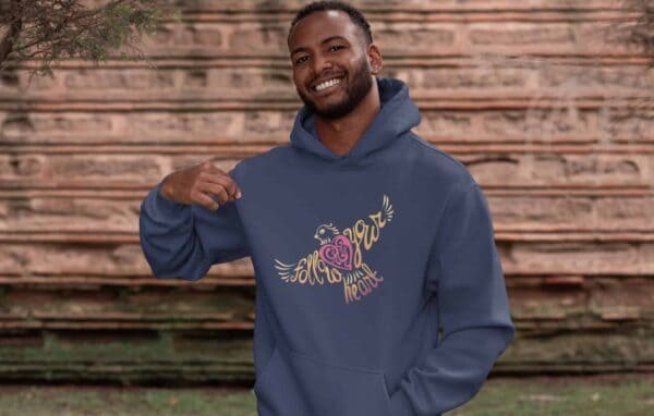 Follow Your Heart Hoodie Design Navy mockup of a smiling man showing off his pullover hoodie