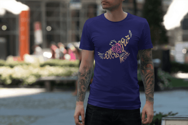 Follow Your Heart T-Shirt Design tee mockup featuring a man with tattooed arms on the street