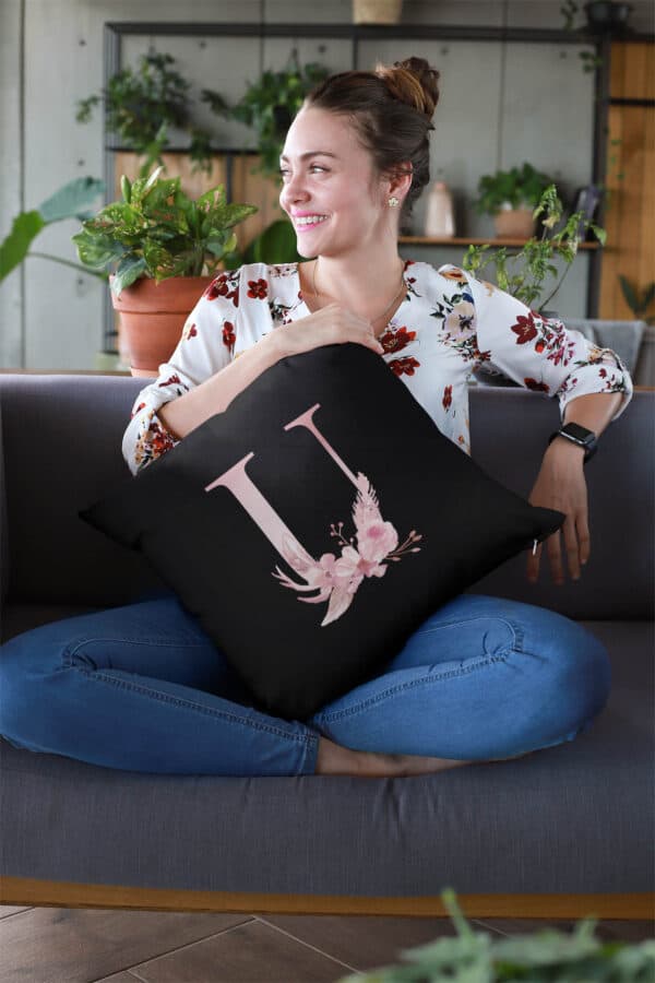 Custom Printed Monogram Letter U on Black Pillow Case mockup of a smiling woman holding a pillow