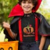 Boy going trick or treat in Halloween costume