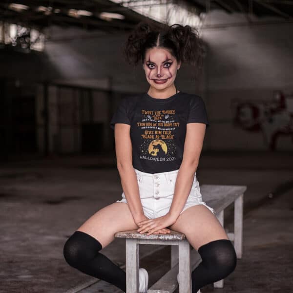 Girl in Halloween costume sitting on a bench in a Twist The Bones Custom Halloween T-shirt